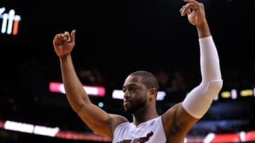 Mar 16, 2014; Miami, FL, USA; Miami Heat guard Dwyane Wade (3) cheer on the fans before tip off against the Houston Rockets at American Airlines Arena. Mandatory Credit: Steve Mitchell-USA TODAY Sports