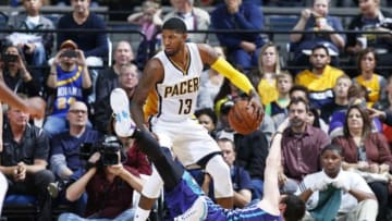 FORT WAYNE, IN - OCTOBER 22: Paul George #13 of the Indiana Pacers gathers a loose ball away from Frank Kaminsky III #44 of the Charlotte Hornets during a preseason game at Allen County War Memorial Coliseum on October 22, 2015 in Fort Wayne, Indiana. The Pacers defeated the Hornets 98-86. NOTE TO USER: User expressly acknowledges and agrees that, by downloading and or using the photograph, User is consenting to the terms and conditions of the Getty Images License Agreement. (Photo by Joe Robbins/Getty Images)