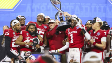 Dec 30, 2020; Arlington, TX, USA; Oklahoma Sooners head coach Lincoln Riley lifts the Cotton Bowl trophy after the game against the Florida Gators at AT&T Stadium. Mandatory Credit: Kevin Jairaj-USA TODAY Sports