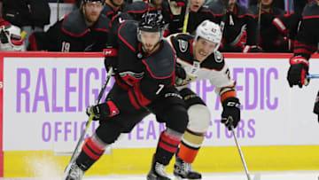 RALEIGH, NC - NOVEMBER 30: Carolina Hurricanes left wing Phillip Di Giuseppe (7) with the puck with Anaheim Ducks right wing Carter Rowney (24) behind him during the 2nd period of the Carolina Hurricanes game versus the Anaheim Ducks on November 30th, 2018 at PNC Arena in Raleigh, NC. (Photo by Jaylynn Nash/Icon Sportswire via Getty Images)