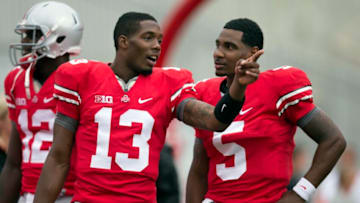 September 8, 2012; Columbus, OH, USA; Ohio State Buckeyes quarterback Kenny Guiton (13) talks with quarterback Braxton Miller (5) before their game against the UCF Knights at Ohio Stadium. Mandatory Credit: Greg Bartram-USA TODAY Sports