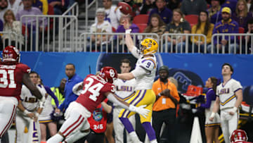 Dec 28, 2019; Atlanta, Georgia, USA; LSU Tigers quarterback Joe Burrow (9) throws the ball against Oklahoma Sooners linebacker David Ugwoegbu (34) during the first quarter of the 2019 Peach Bowl college football playoff semifinal game. Mandatory Credit: Brett Davis-USA TODAY Sports