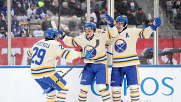 HAMILTON, ONTARIO - MARCH 13: Vinnie Hinostroza #29, Peyton Krebs #19 and Mark Pysyk #13 of the Buffalo Sabres celebrate a goal against the Toronto Maple Leafs in the second period during the Heritage Classic at Tim Hortons Field on March 13, 2022 in Hamilton, Ontario. (Photo by Claus Andersen/Getty Images)