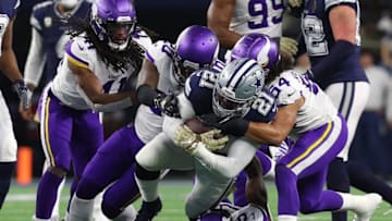 ARLINGTON, TEXAS - NOVEMBER 10: Ezekiel Elliott #21 of the Dallas Cowboys is brought down by Alexander Mattison #25, Eric Kendricks #54 and Mackensie Alexander #20 of the Minnesota Vikings at AT&T Stadium on November 10, 2019 in Arlington, Texas. (Photo by Richard Rodriguez/Getty Images)