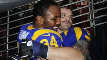 Dec 22, 2013; St. Louis, MO, USA; St. Louis Rams defensive end Robert Quinn (94) celebrates with defensive end Chris Long (91) after getting his franchise leading eighteenth sack of the season against the Tampa Bay Buccaneers during the second half at the Edward Jones Dome. The Rams defeated the Buccaneers 23-13. Mandatory Credit: Jeff Curry-USA TODAY Sports