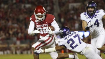 Nov 23, 2019; Norman, OK, USA; Oklahoma Sooners running back Kennedy Brooks (26) runs as TCU Horned Frogs safety Ar'Darius Washington (27) defends during the first quarter at Gaylord Family - Oklahoma Memorial Stadium. Mandatory Credit: Kevin Jairaj-USA TODAY Sports