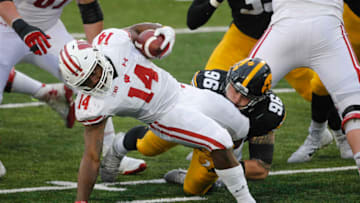 Dec 12, 2020; Iowa City, IA, USA; Iowa senior defensive lineman Jack Heflin tackles Wisconsin running back Nakia Watson in the backfield for a loss of yards in the second quarter on Saturday, Dec. 12, 2020, at Kinnick Stadium in Iowa City, Iowa. Mandatory Credit: Byron Houlgrave-USA TODAY NETWORK