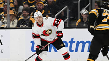 BOSTON, MASSACHUSETTS - MARCH 21: Dylan Gambrell #27 of the Ottawa Senators sets up to move the puck against Connor Clifton #75 of the Boston Bruins during the second period at the TD Garden on March 21, 2023 in Boston, Massachusetts. (Photo by Brian Fluharty/Getty Images)