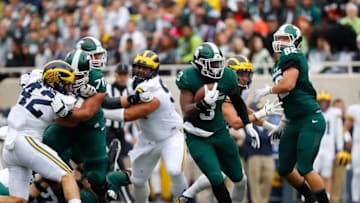 EAST LANSING, MI - OCTOBER 29: LJ Scott #3 of the Michigan State Spartans runs for a first down in the first quarter of the game against the Michigan Wolverines at Spartan Stadium on October 29, 2016 in East Lansing, Michigan. Michigan defeated Michigan State 32-23. (Photo by Leon Halip/Getty Images)