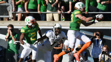 EUGENE, OR - SEPTEMBER 24: Wide receiver Brenden Schooler #43 of the Oregon Ducks intercepts a pass intended for wide receiver Shay Fields #1 of the Colorado Buffaloes as defensive back Tyree Robinson #2 of the Oregon Ducks closes in during the third quarter of the game at Autzen Stadium on September 24, 2016 in Eugene, Oregon. Colorado won the game 41-38. (Photo by Steve Dykes/Getty Images)