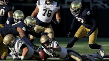 SOUTH BEND, INDIANA - NOVEMBER 16: Malcolm Perry #10 of the Navy Midshipmen fumbles the ball in the second quarter against the Wisconsin Badgers at Notre Dame Stadium on November 16, 2019 in South Bend, Indiana. (Photo by Dylan Buell/Getty Images)