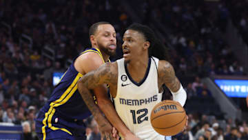 SAN FRANCISCO, CALIFORNIA - JANUARY 25: Ja Morant #12 of the Memphis Grizzlies drives to the basket against Stephen Curry #30 of the Golden State Warriors in the second quarter at Chase Center on January 25, 2023 in San Francisco, California. NOTE TO USER: User expressly acknowledges and agrees that, by downloading and/or using this photograph, User is consenting to the terms and conditions of the Getty Images License Agreement. (Photo by Lachlan Cunningham/Getty Images)