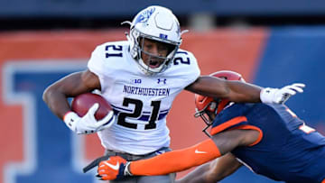 CHAMPAIGN, IL - NOVEMBER 25: Northwestern Wildcats running back Justin Jackson (21) is wrapped up by Illinois Fighting Illini linebacker Del'Shawn Phillips (3) during the game between the Illinois Fighting Illini and the Northwestern Wildcats on November 25, 2017 at Memorial Stadium in Champaign, Illinois. (Photo by Quinn Harris/Icon Sportswire via Getty Images)