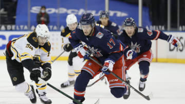 Feb 28, 2021; New York, New York, USA; Kevin Rooney #17 of the New York Rangers controls the puck as Jake DeBrusk #74 of the Boston Bruins defends during the second period at Madison Square Garden. Mandatory Credit: Sarah Stier/Pool Photo-USA TODAY Sports