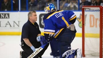 Feb 22, 2016; St. Louis, MO, USA; St. Louis Blues trainer Ray Barile checks on goalie Brian Elliott (1) after he was injured during the first period against the San Jose Sharks at Scottrade Center. Mandatory Credit: Jeff Curry-USA TODAY Sports