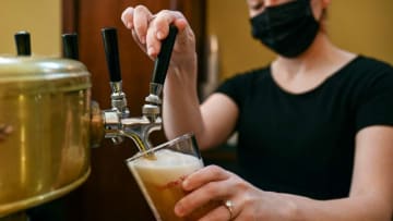 Bartender pours a beer