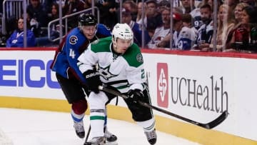 Oct 15, 2016; Denver, CO, USA; Colorado Avalanche defenseman Tyson Barrie (4) and Dallas Stars left wing Antoine Roussel (21) battle for the puck in the third period at the Pepsi Center. The Avalanche won 6-5. Mandatory Credit: Isaiah J. Downing-USA TODAY Sports