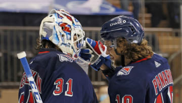 Apr 15, 2021; New York, New York, USA; Igor Shesterkin #31 and Artemi Panarin #10 of the New York Rangers celebrate their 4-0 shutout against the New Jersey Devilsat Madison Square Garden. Mandatory Credit: Bruce Bennett/POOL PHOTOS-USA TODAY Sports