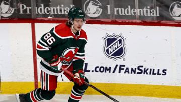 NEWARK, NEW JERSEY - MARCH 06: Jack Hughes #86 of the New Jersey Devils takes the puck in the second period against the New York Rangers at Prudential Center on March 06, 2021 in Newark, New Jersey.A limited number of fans are in attendance due to COVID-19 restrictions. (Photo by Elsa/Getty Images)