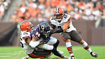 CLEVELAND, OHIO - AUGUST 27: Linebacker Jeremiah Owusu-Koramoah #28 and linebacker Sione Takitaki #44 of the Cleveland Browns tackle wide receiver Dante Pettis #86 of the Chicago Bears during the first quarter of a preseason game at FirstEnergy Stadium on August 27, 2022 in Cleveland, Ohio. (Photo by Jason Miller/Getty Images)