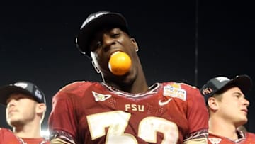 MIAMI GARDENS, FL - JANUARY 01: James Wilder Jr. #32 of the Florida State Seminoles celebrates with an orange after they won 31-10 against the Northern Illinois Huskies during the Discover Orange Bowl at Sun Life Stadium on January 1, 2013 in Miami Gardens, Florida. (Photo by Streeter Lecka/Getty Images)