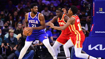 Oct 30, 2021; Philadelphia, Pennsylvania, USA; Philadelphia 76ers center Joel Embiid (21) controls the ball against Atlanta Hawks center Clint Capela (15) and forward De'Andre Hunter (12) in the first quarter at Wells Fargo Center. Mandatory Credit: Kyle Ross-USA TODAY Sports