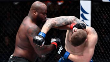 LAS VEGAS, NEVADA - DECEMBER 18: (L-R) Derrick Lewis punches Chris Daukaus in their heavyweight fight during the UFC Fight Night event at UFC APEX on December 18, 2021 in Las Vegas, Nevada. (Photo by Jeff Bottari/Zuffa LLC)
