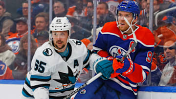 Edmonton Oilers forward Connor McDavid (97) and San Jose Sharks defensemen Erik Karlsson (65) battle along the boards. Mandatory Credit: Perry Nelson-USA TODAY Sports