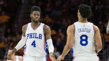 Feb 26, 2016; Philadelphia, PA, USA; Philadelphia 76ers forward Nerlens Noel (4) celebrates with center Jahlil Okafor (8) after a score against the Washington Wizards during the second quarter at Wells Fargo Center. Mandatory Credit: Bill Streicher-USA TODAY Sports