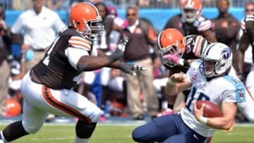 Oct 5, 2014; Nashville, TN, USA; Tennessee Titans quarterback Jake Locker (10) slides against Cleveland Browns Ahtyba Rubin (71) during the first half at LP Field. Mandatory Credit: Don McPeak-USA TODAY Sports