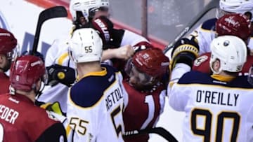 Jan 18, 2016; Glendale, AZ, USA; Buffalo Sabres defenseman Zach Bogosian (47) punches Arizona Coyotes left wing Anthony Duclair (10) after the conclusion of the game at Gila River Arena. Mandatory Credit: Matt Kartozian-USA TODAY Sports
