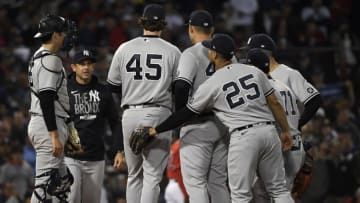 Oct 5, 2021; Boston, Massachusetts, USA; New York Yankees manager Aaron Boone (17) pulls starting pitcher Gerrit Cole (45) during the third inning against the Boston Red Sox in the American League Wildcard game at Fenway Park. Mandatory Credit: Bob DeChiara-USA TODAY Sports