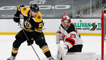 Mar 28, 2021; Boston, Massachusetts, USA; Boston Bruins left wing Nick Ritchie (21) deflects a shot in front of New Jersey Devils goaltender Mackenzie Blackwood (29) during the third period at TD Garden. Mandatory Credit: Winslow Townson-USA TODAY Sports