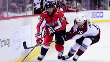 WASHINGTON, DC - DECEMBER 12: Devante Smith-Pelly #25 of the Washington Capitals and Sven Andrighetto #10 of the Colorado Avalanche battle for the puck in the first period at Capital One Arena on December 12, 2017 in Washington, DC. (Photo by Patrick McDermott/NHLI via Getty Images)