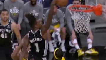 San Antonio Spurs guard Lonnie Walker posterizes two Indiana Pacers players. 