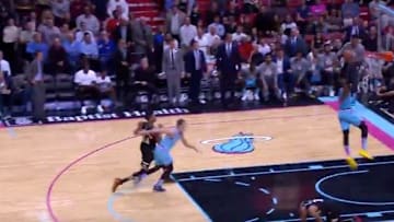 Milwaukee Bucks' Giannis Antetokounmpo lowers his shoulder into Miami Heat PG Goran Dragic