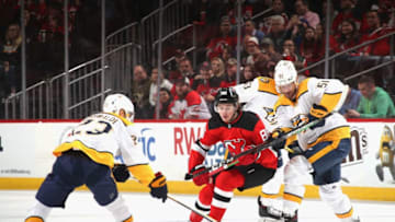 NEWARK, NEW JERSEY - JANUARY 30: Rocco Grimaldi #23 and Austin Watson #51 of the Nashville Predators defend against Jack Hughes #86 of the New Jersey Devils during the first period at the Prudential Center on January 30, 2020 in Newark, New Jersey. (Photo by Bruce Bennett/Getty Images)
