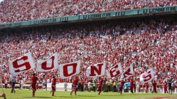 NORMAN, OK - SEPTEMBER 18: Oklahoma Sooners cheerleaders run across the field with Sooners flags after a 100-yard return on a blocked point-after-touchdown for two points against the Nebraska Cornhuskers at Gaylord Family Oklahoma Memorial Stadium on September 18, 2021 in Norman, Oklahoma. Oklahoma won 23-16. (Photo by Brian Bahr/Getty Images)