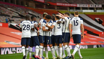 Tottenham Hotspur players celebrate after Harry Kane scored their third goal during the English Premier League football match between Manchester United and Tottenham Hotspur at Old Trafford in Manchester, north west England, on October 4, 2020. (Photo by Oli SCARFF / AFP) / RESTRICTED TO EDITORIAL USE. No use with unauthorized audio, video, data, fixture lists, club/league logos or 'live' services. Online in-match use limited to 120 images. An additional 40 images may be used in extra time. No video emulation. Social media in-match use limited to 120 images. An additional 40 images may be used in extra time. No use in betting publications, games or single club/league/player publications. / (Photo by OLI SCARFF/AFP via Getty Images)