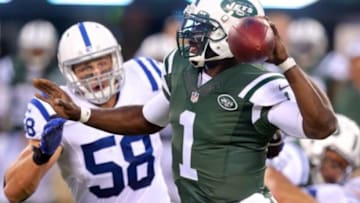 Aug 7, 2014; East Rutherford, NJ, USA; New York Jets quarterback Michael Vick (1) drops back to pass while pressured by Indianapolis Colts linebacker Andy Studebaker (58) during the second quarter of a game at MetLife Stadium. Mandatory Credit: Brad Penner-USA TODAY Sports