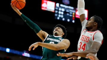 Feb 12, 2023; Columbus, Ohio, USA; Michigan State Spartans guard Jaden Akins (3) goers in for the layup as Ohio State Buckeyes center Felix Okpara (34) defends during the first half at Value City Arena. Mandatory Credit: Joseph Maiorana-USA TODAY Sports