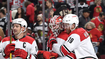 CHICAGO, IL - NOVEMBER 08: Justin Williams #14, goalie Scott Darling #33 and Dougie Hamilton #19 of the Carolina Hurricanes celebrate after defeating the Chicago Blackhawks 4-3 at the United Center on November 8, 2018 in Chicago, Illinois. (Photo by Bill Smith/NHLI via Getty Images)