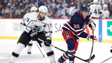 Nov 13, 2021; Winnipeg, Manitoba, CAN; Los Angeles Kings right wing Alex Iafallo (19) battles with Winnipeg Jets right wing Blake Wheeler (26) in the second period at Canada Life Centre. Mandatory Credit: James Carey Lauder-USA TODAY Sports