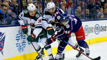 COLUMBUS, OH - JANUARY 30: Joel Eriksson Ek #14 of the Minnesota Wild, Marcus Foligno #17 of the Minnesota Wild and Dean Kukan #46 of the Columbus Blue Jackets battle for control of the puck during the first period on January 30, 2018 at Nationwide Arena in Columbus, Ohio. (Photo by Kirk Irwin/Getty Images)