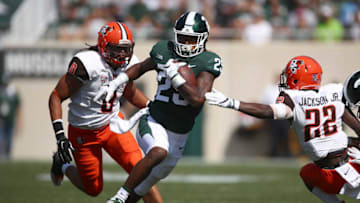 EAST LANSING, MI - SEPTEMBER 02: Darrell Stewart Jr. #25 of the Michigan State Spartans tries to avoid a tackle by Robert Jackson Jr. #22 of the Bowling Green Falcons at Spartan Stadium on September 2, 2017 in East Lansing, Michigan. Michigan State won the game 35-10. (Photo by Gregory Shamus/Getty Images)