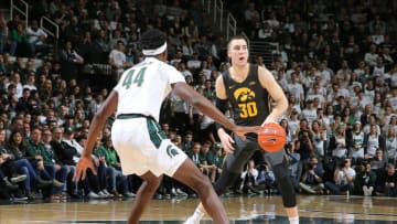 EAST LANSING, MI - FEBRUARY 25: Connor McCaffery #30 of the Iowa Hawkeyes handles the ball while defended by Gabe Brown #44 of the Michigan State Spartans in the second half of the game at the Breslin Center on February 25, 2020 in East Lansing, Michigan. (Photo by Rey Del Rio/Getty Images)