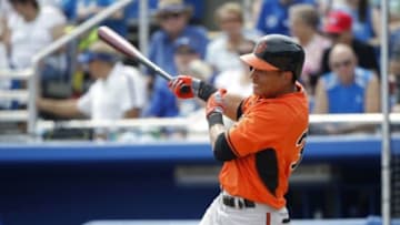 Mar 16, 2014; Dunedin, FL, USA; Baltimore Orioles center fielder Quintin Berry (34) singles during the seventh inning against the Toronto Blue Jays at Florida Auto Exchange Park. Mandatory Credit: Kim Klement-USA TODAY Sports