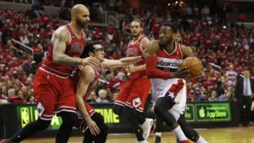 Apr 25, 2014; Washington, DC, USA; Washington Wizards guard John Wall (2) dribbles the ball against Chicago Bulls guard Kirk Hinrich (12) and Bulls forward Carlos Boozer (5) in the first quarter in game three of the first round of the 2014 NBA Playoffs at Verizon Center. Mandatory Credit: Geoff Burke-USA TODAY Sports