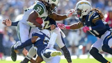 Oct 5, 2014; San Diego, CA, USA; New York Jets running back Chris Ivory (33) is stopped by San Diego Chargers free safety Eric Weddle (32) and strong safety Marcus Gilchrist (bottom) and defensive back Jahleel Addae (right) during the second quarter at Qualcomm Stadium. Mandatory Credit: Jake Roth-USA TODAY Sports