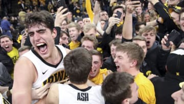 IOWA CITY, IOWA- FEBRUARY 01: Forward Luka Garza #55 and guard Austin Ash #13 of the Iowa Hawkeyes celebrates with fans after the upset over the Michigan Wolverines on February 1, 2019 at Carver-Hawkeye Arena, in Iowa City, Iowa. (Photo by Matthew Holst/Getty Images)